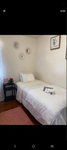 two beds in a room with white walls at NH room rental in Akron