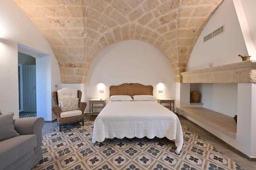 a large bedroom with a bed and a couch at Corte di Torre Spaccata in Torre Canne