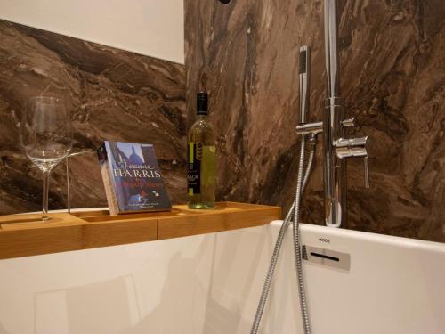 a bottle of wine and a book on a counter at 2 Bed in Skipton oc-75646 in Grassington