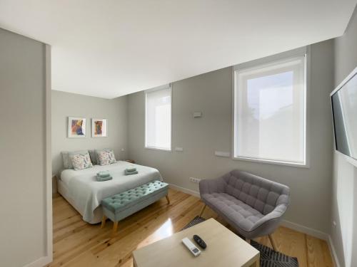 a living room with a bed and a couch at Allegro Patio House in Porto