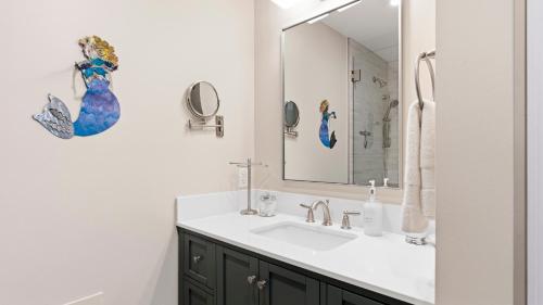 a bathroom with a sink and a mirror at Treehouse at BootLegger Cove in Bluffton