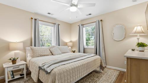 a bedroom with a bed and two windows at Treehouse at BootLegger Cove in Bluffton