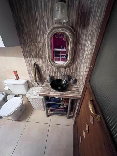 a bathroom with a sink and a mirror at Hospedaje San Luis Sierras in Juana Koslay 