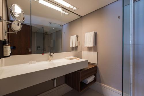 a bathroom with a sink and a mirror at Hotel da Bahia by Wish in Salvador