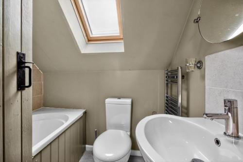 a bathroom with a sink and a toilet and a bath tub at 2 Bed in Taunton oc-conco in West Monkton