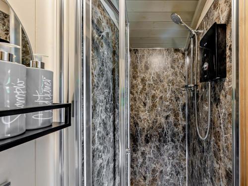 a bathroom with a shower with a glass door at 1 Bed in Bala oc-85259 in Frongoch
