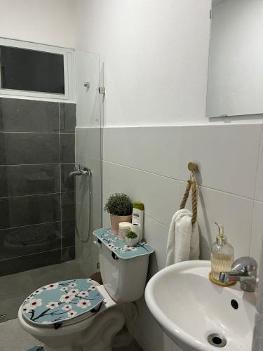 a bathroom with a toilet and a sink at Calm Stay Monte Plata in Monte Plata