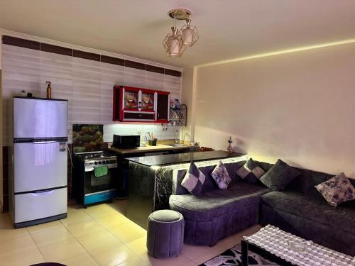 a living room with a couch and a kitchen at Lasirena in Ain Sokhna
