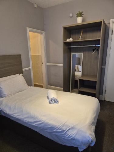 a bedroom with a bed with a towel on it at The Old Victoria in Penrith
