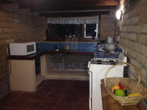 a kitchen with a sink and a stove top oven at Cabañas Hojarasca in Mineral del Chico