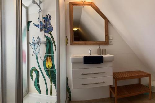 a bathroom with a sink and a shower with a mirror at Apartmány Maříž in Maříž
