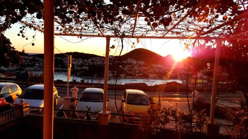 a group of cars parked in a parking lot at sunset at Guesthouse Perica in Dubrovnik