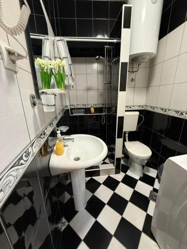 a black and white bathroom with a sink and a toilet at Casa Di Porto in Kotor
