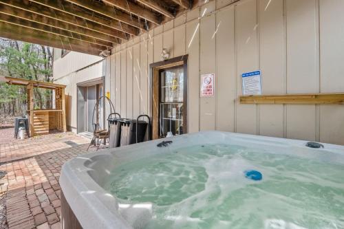 a jacuzzi tub sitting outside of a building at Good Lodge - Hot Tub Beach Access Pool Table in Lake Harmony