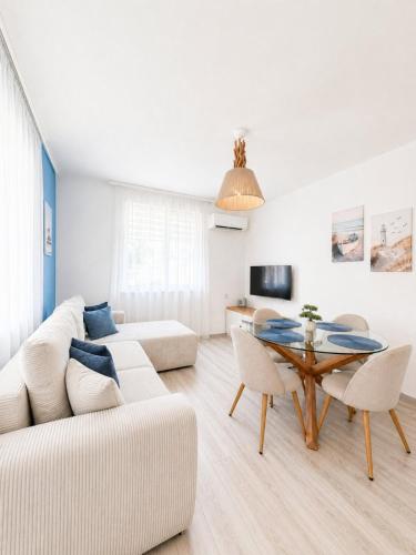 a living room with a couch and a table at Апартамент Tiana 2 in Tsarevo