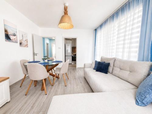 a living room with a couch and a table at Апартамент Tiana 2 in Tsarevo