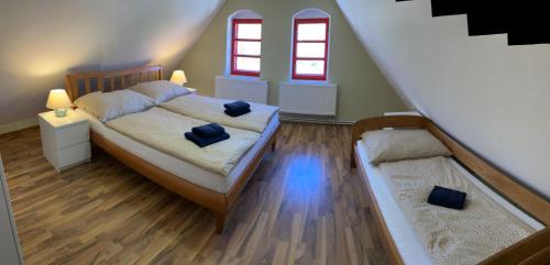 a bedroom with a bed with two blue pillows on it at Apartmány Maříž in Maříž
