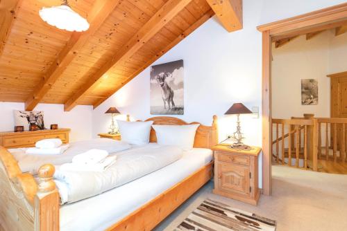 a bedroom with two beds and a wooden ceiling at Ferienwohnung Elisabeth in Reit im Winkl