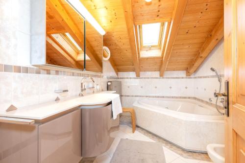 a bathroom with a tub and a sink at Ferienwohnung Elisabeth in Reit im Winkl