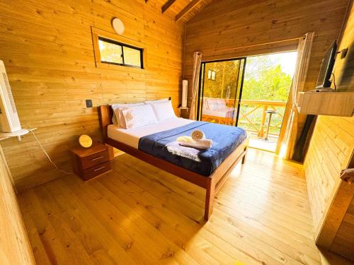 a bedroom with a bed in a wooden cabin at El Canto del Manglar in Nuquí