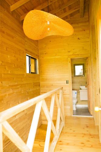 a staircase in a log cabin with a large chandelier at El Canto del Manglar in Nuquí
