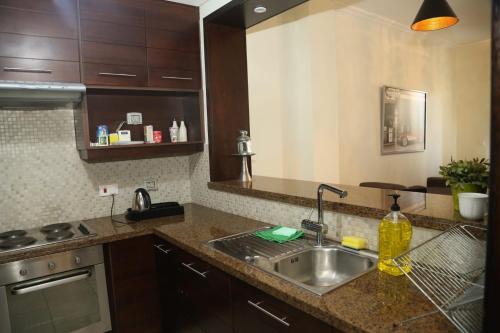 a kitchen with a sink and a counter top at Apartment at Samarah Resort DeadSea C13-Families & couples only in Sowayma