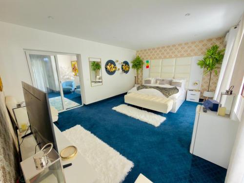 a bedroom with a bed and a blue carpet at lunera Immo in Dakan