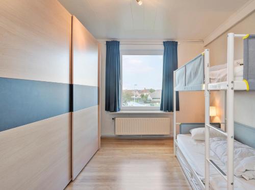 a bedroom with two bunk beds and a window at Ringlaan 70 2V0201 in Wenduine