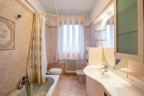 a bathroom with a tub and a sink and a toilet at Appartamento Mary Monte Grappa in Borso del Grappa