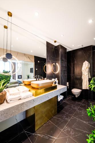 a bathroom with a tub and a sink and a toilet at Premium Hotel, Novi Sad in Novi Sad