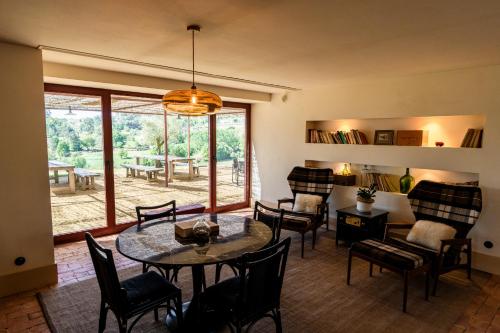 a living room with a table and chairs at Taboadella Casa Villae 1255 - Relais & Châteaux in Penalva do Castelo