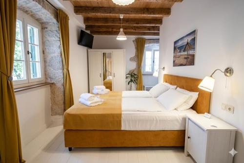 a bedroom with a large bed with towels on it at Villa Ca'Pietra, rustic stone house in Malinska