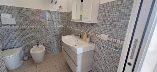 a bathroom with a sink and a toilet at Miramare Castello in Castelsardo