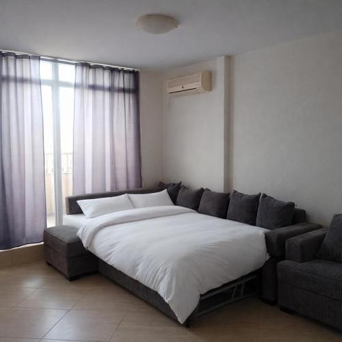 a bedroom with a large bed and a couch at Midia Resort Aheloy in Aheloy