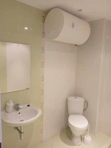 a bathroom with a toilet and a sink at Midia Resort Aheloy in Aheloy