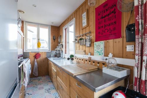 a kitchen with wood paneled walls and a counter top at Chalet le 22 Agniéres in Le Dévoluy