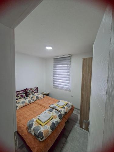 a bedroom with a bed with towels on it at Adagio Studio Apartment in Plav