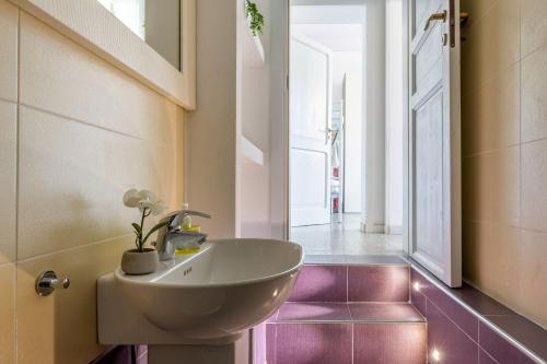 a bathroom with a white sink and a hallway at Italian Experience-Casale Oleandro Marino in Porto Recanati