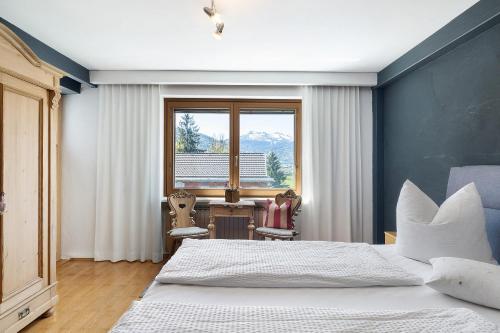 a bedroom with a bed and a large window at Försterhaus Wohnung Obergeschoss in Egg