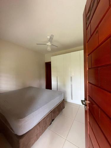 a bedroom with a bed and a ceiling fan at Rancho Rocha in Buritama