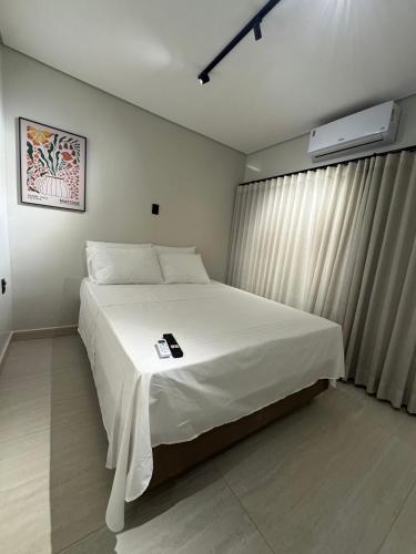a bedroom with a large white bed with a white blanket at You Smart Flats - Hotel in Formosa