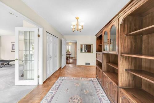 a hallway with wooden shelves in a home with a living room at Spacious house 6 bedroom near ferry in Delta