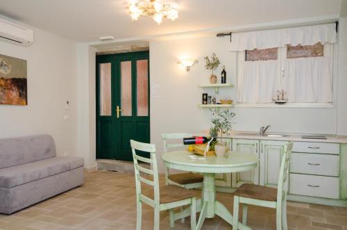 a kitchen and living room with a table and a couch at Casa Matteotti in Rovinj