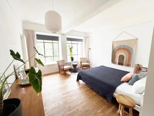 a bedroom with a king sized bed and a living room at Seven Rooms Hamburg in Hamburg
