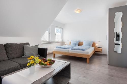 a living room with a couch and a table at Seetraum Berger in Hagnau