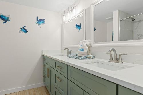 a bathroom with a sink and a mirror at Pinnacle Port, C2-603 in Panama City Beach