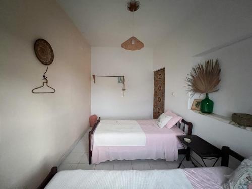 two beds in a small room with pink and white sheets at Casa Tota in Assomada
