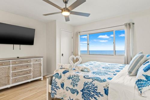 a bedroom with a bed and a large window at Pinnacle Port, C2-603 in Panama City Beach