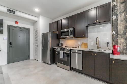 a kitchen with black cabinets and stainless steel appliances at Park Hotel Studio Suite 511 in Chattanooga