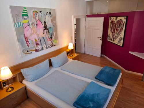 a bedroom with a bed with two blue pillows at Ferienwohnung Lienz Egger in Lienz